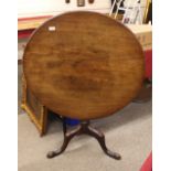 A George III mahogany circular snap top occasional table, raised on baluster column and tripod base