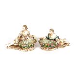 A pair of 19th Century Meissen style sweetmeat stands, in the form of reclining lady and beau,