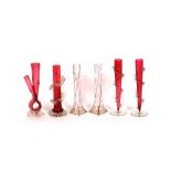 A pair of clear glass specimen vases, with ruby flash line decoration; and four various cranberry