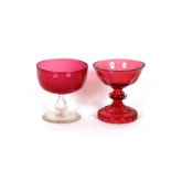 A heavy cranberry glass Tazza, with thumb press decoration; and a cranberry goblet on clear glass