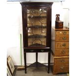 A 19th Century mahogany and glazed corner display cabinet, on single drawer stand, square tapering