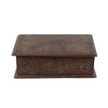 A 17th Century oak Bible box, the carved frieze with roundel decoration bearing dated 1656, 55.5cm