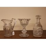 An antique cut glass water jug; a heavy Victorian glass pedestal bowl; and a cut glass maul shaped