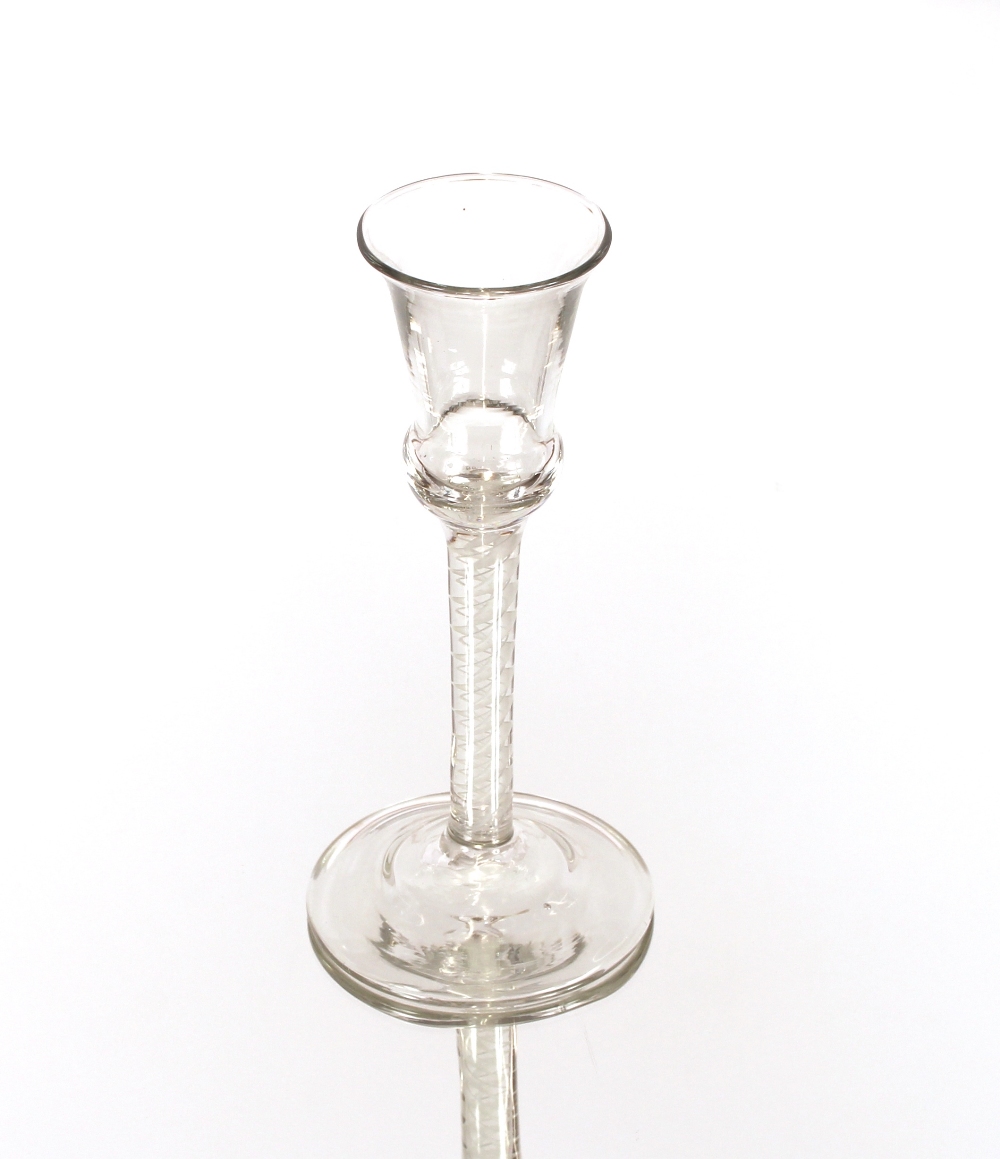 An antique wine glass, having bell shaped bowl and cotton twist spiral stem on circular spread foot,