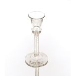 An antique wine glass, having bell shaped bowl and cotton twist spiral stem on circular spread foot,