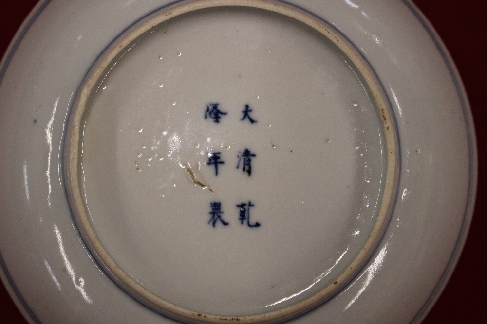 An 18th Century Chinese saucer dish, decorated in under glaze blue with flower heads - Image 6 of 6