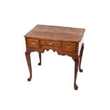 An 18th Century oak and elm lowboy, the top with sunburst motif and chequer banding, three short