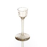 An antique wine glass, having vine decorated bowl and cotton twist stem, on circular spread foot,