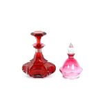 A cranberry glass scent flask, having octagonal faceted stopper and a small baluster scent flask