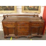 An 18th Century oak dresser, having separate open plate rack, the inverted break front base fitted