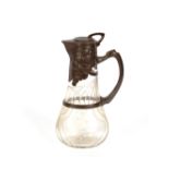 A cut glass and pewter mounted Art Nouveau claret jug, 30cm high