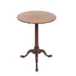 A George III mahogany tilt top occasional table, raised on a turned column tripod base,