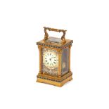 A brass and champleve enamel striking carraige clock, with repeat movement 19cm high
