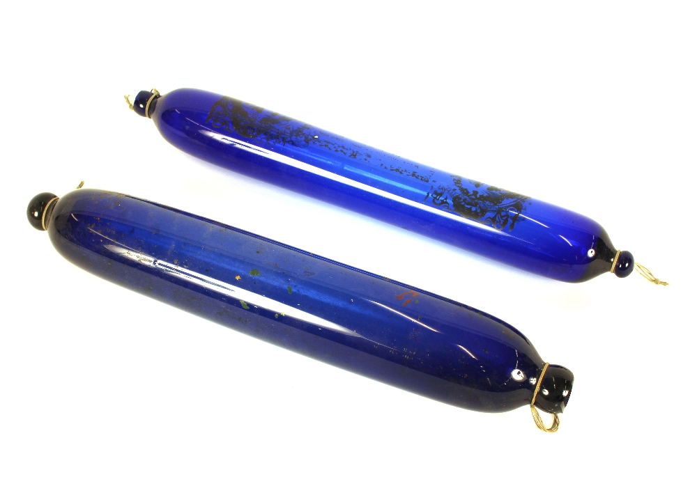 Two 19th Century blue glass rolling pins, 41cm long