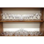 A large collection of cut glass table ware, including various sized wine glasses, sherrys, ports and