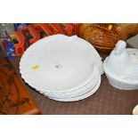 A quantity of scallop shaped dinner plates