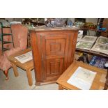 A Georgian oak hanging corner cupboard