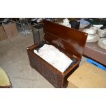 A carved oak blanket box