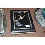 A black lacquered and inlaid photo album lacking c