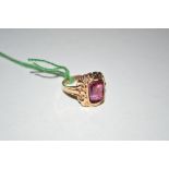 A 14ct gold and red stone set ring