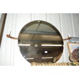 A large circular bevel edged wall mirror with scon