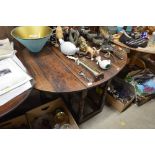 An antique oak drop leaf table