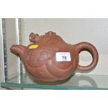 A Chinese terracotta teapot with dragon decoration