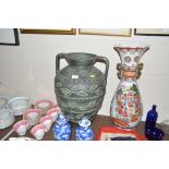 A large pottery green glazed twin handled vase