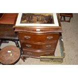 A reproduction mahogany serpentine three drawer ch