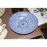 A pottery pedestal bowl with blue painted decorati