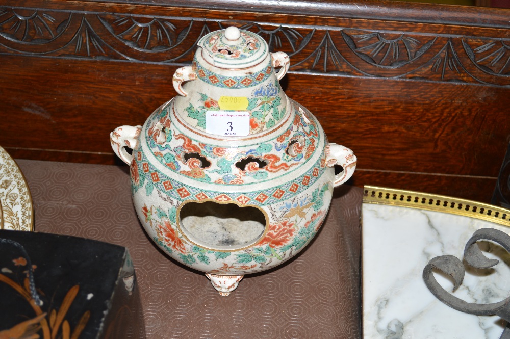 A Japanese incense burner with floral decoration