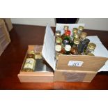 A box containing 18 miniature whisky's and a minia