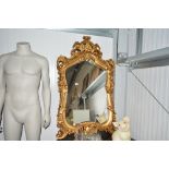 A large gilt framed decorative wall mirror