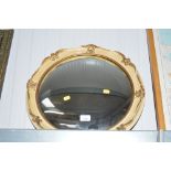 A gilt framed convex wall mirror