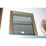A gilt metal mounted framed wall mirror