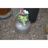 A stainless steel milk churn and contents