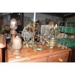 A collection of various brass candelabra; a candle