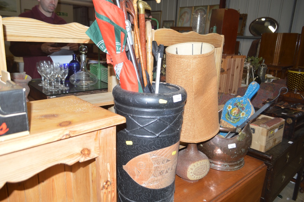A pottery stick stand containing various walking s