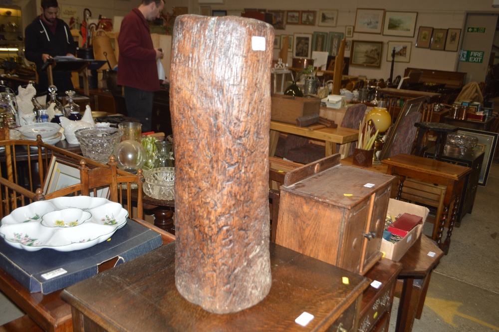 A rustic wooden dug out stick stand