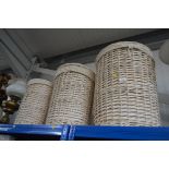 A graduating set of three wicker laundry baskets