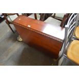 A reproduction mahogany drop leaf table