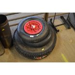 Two wheelbarrow wheels and a tyre