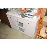 A painted wooden sideboard fitted three drawers