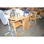 A beech drop leaf dining table with a set of four