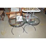 A pair of glass and chrome tables