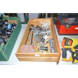 A wooden drawer containing air tools