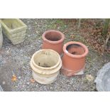 A terracotta chimney pot and one other chimney pot