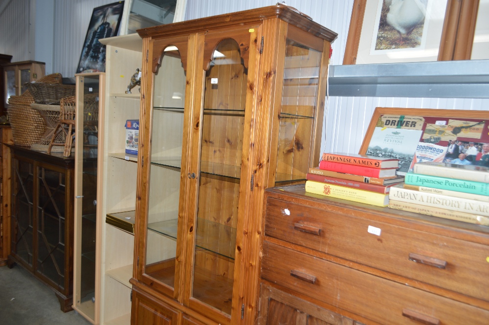 A modern pine and glazed display cabinet