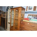 A modern pine and glazed display cabinet