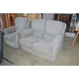 An upholstered two seater settee with matching arm